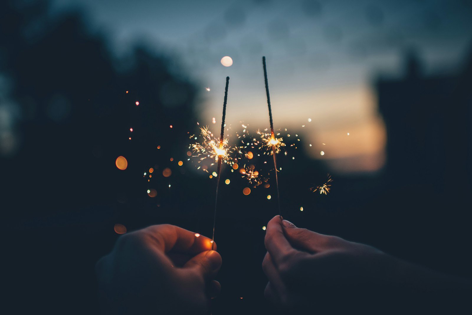 Holding lit sparklers safely at arm's length